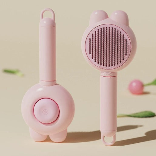 Cepillo autolimpiante para mascotas diseño conejo color rosa, vista frontal y trasera