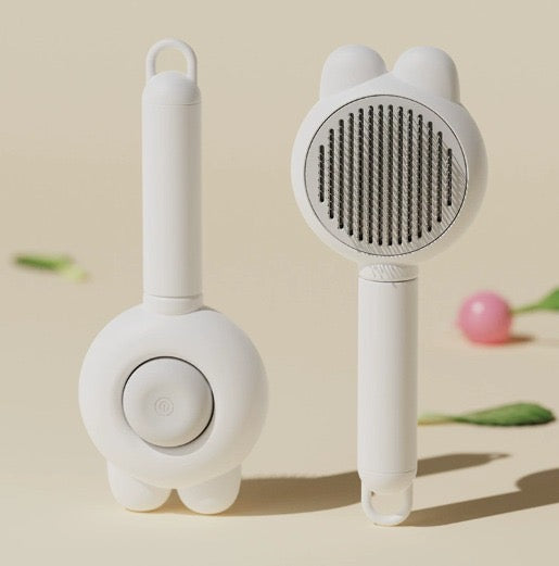 Cepillo autolimpiante para mascotas diseño conejo color blanco, vista frontal y trasera